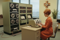 1960's style computer with a vintage secretary style lady typing 